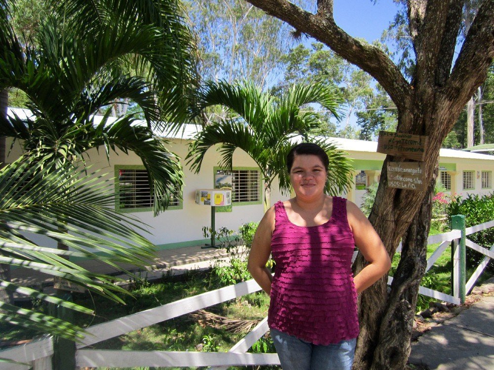 Woman smiling with palm trees in background