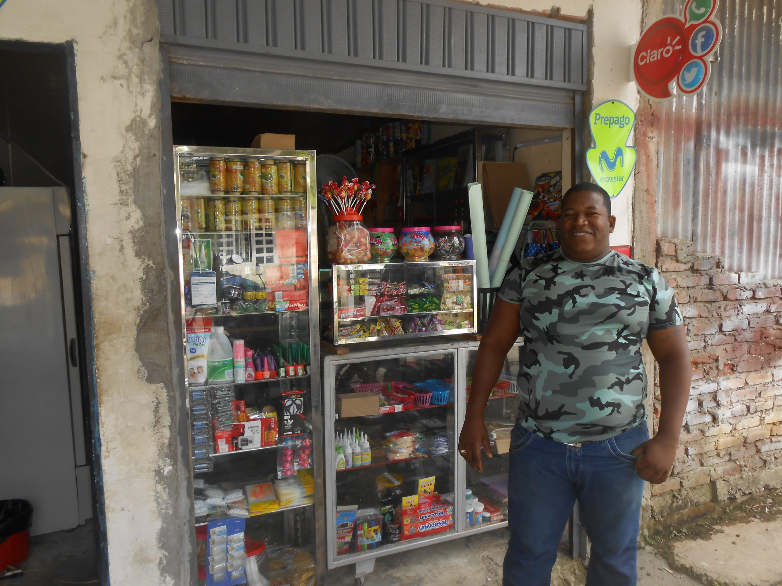 Man in front of small shop