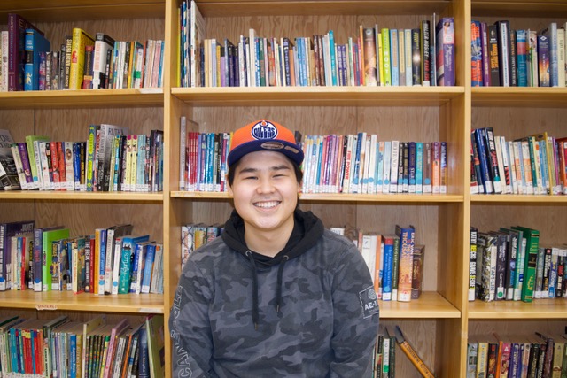 Young man smiling at the library
