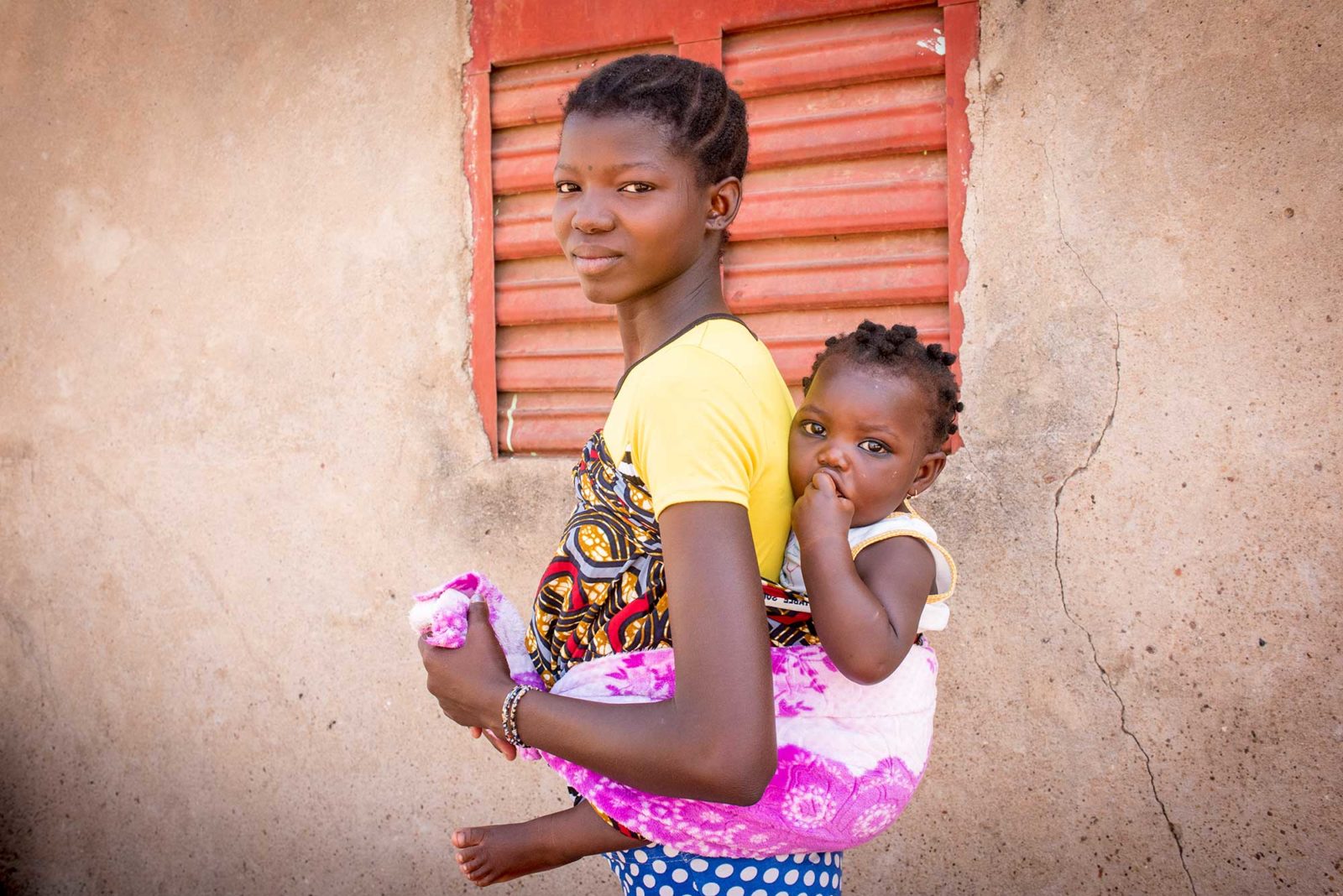 Woman carrying a baby on her back