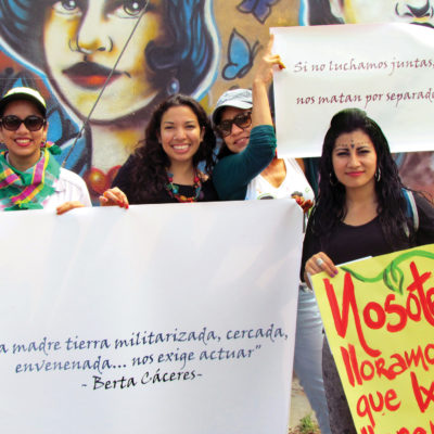 Women holding banners and signs