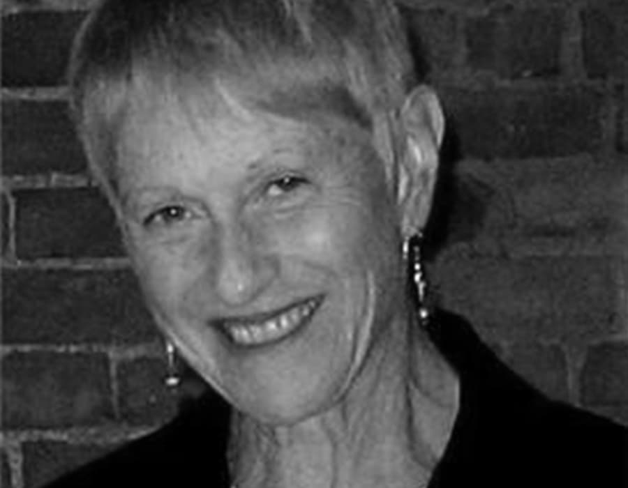 Diane, an older woman with short blonde hair smiling at the camera