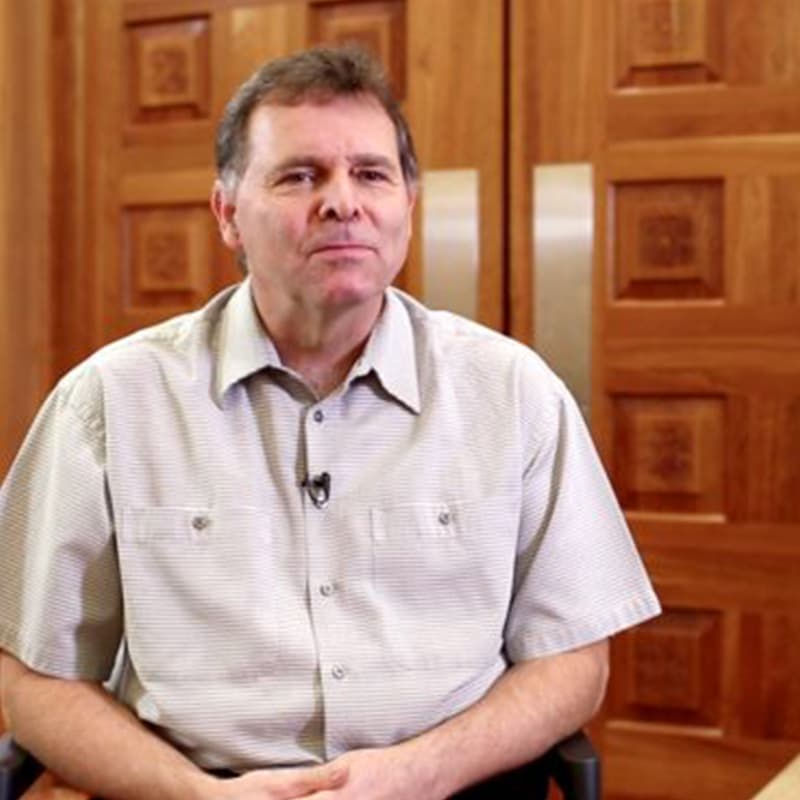 Portrait of Chris in front of wooden doors