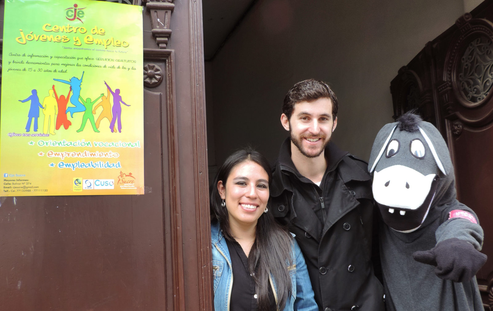 Three people, one in donkey costume