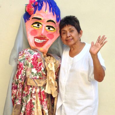 Woman with a person wearing a decorative mask