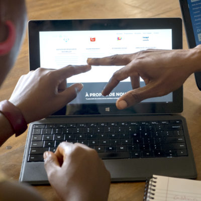 Hands pointing at tablet screen