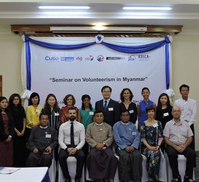 Group photo with sign reading Seminar in Myanmar