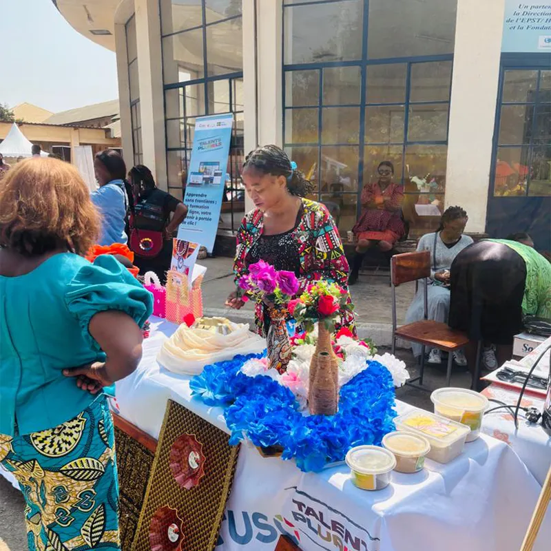 Outreach booth with staff engaging visitors outdoors / Stand de sensibilisation avec équipe accueillant des visiteurs en extérieur